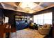 Elegant living room with a coffered ceiling, chandelier, and stylish decor at 35 Rock Rose Dr, Covington, GA 30014