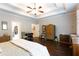 Bright main bedroom with hardwood floors, tray ceilings, ceiling fan, and walk-in closet at 35 Rock Rose Dr, Covington, GA 30014