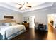 Bright main bedroom features hardwood floors, tray ceilings, and a ceiling fan at 35 Rock Rose Dr, Covington, GA 30014