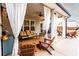 Outdoor patio area featuring comfortable seating and curtains for privacy at 35 Rock Rose Dr, Covington, GA 30014