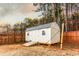 Outdoor storage shed in the backyard, enclosed by a wooden fence, providing extra space at 35 Rock Rose Dr, Covington, GA 30014