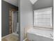 Bathroom featuring a soaking tub with a view to a shower at 526 Lakeside Dr, Hiram, GA 30141