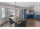 Eat-in-kitchen dining room featuring an elegant light fixture and bay window offering plenty of natural light at 526 Lakeside Dr, Hiram, GA 30141