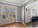 Inviting foyer featuring hardwood floors, double doors to the porch, and light gray walls at 526 Lakeside Dr, Hiram, GA 30141