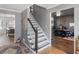 Hallway with a staircase leading to the upper level, and views into the dining and office spaces at 526 Lakeside Dr, Hiram, GA 30141
