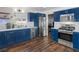 Modern kitchen featuring blue cabinetry, stainless steel appliances, and hardwood floors at 526 Lakeside Dr, Hiram, GA 30141