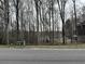 Great street view of the lake, surrounded by mature trees at 526 Lakeside Dr, Hiram, GA 30141