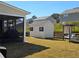 Backyard featuring a shed and a screened-in porch, offering a perfect space for relaxation at 60 Cottontail Lane, Villa Rica, GA 30180