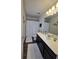 Bright bathroom with white countertop, dark cabinets, and modern fixtures at 60 Cottontail Lane, Villa Rica, GA 30180
