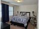 Comfortable bedroom featuring a bed with patterned bedding and soft lighting at 60 Cottontail Lane, Villa Rica, GA 30180