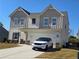Charming two-story home with a large driveway and inviting curb appeal at 60 Cottontail Lane, Villa Rica, GA 30180