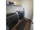 Practical laundry room with modern washer and dryer, and shelving for storage at 60 Cottontail Lane, Villa Rica, GA 30180