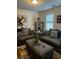 Comfortable living room with stylish furniture, accent pillows and a plant at 60 Cottontail Lane, Villa Rica, GA 30180
