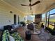 Inviting sunroom with comfortable seating, a brick fireplace, and views of the backyard at 60 Cottontail Lane, Villa Rica, GA 30180