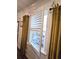 Window showing shutters and gold drapes adding character and charm at 60 Cottontail Lane, Villa Rica, GA 30180