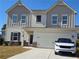 Charming two-story home with a two-car garage, manicured lawn, and inviting curb appeal in a Gathering-friendly neighborhood at 60 Cottontail Ln, Villa Rica, GA 30180