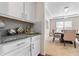 Dining room with modern chandelier, wet bar with granite countertops, and neutral paint at 6801 Louis Dr, Locust Grove, GA 30248
