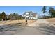 Beautifully landscaped two-story home with a long driveway and a mailbox at 6801 Louis Dr, Locust Grove, GA 30248