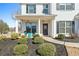Inviting front porch with decorative door wreath and manicured landscaping at 6801 Louis Dr, Locust Grove, GA 30248