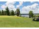 Picturesque golf course with lush green fairways overlooking a serene lake, perfect for recreation and relaxation at 6801 Louis Dr, Locust Grove, GA 30248