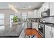 Beautiful kitchen with granite countertops, stainless steel appliances, and modern lighting at 6801 Louis Dr, Locust Grove, GA 30248