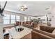 Open concept living room with large windows, hardwood floors, and modern furnishings at 6801 Louis Dr, Locust Grove, GA 30248