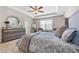 Serene main bedroom with tray ceiling, soothing color scheme, and decorative mirror at 6801 Louis Dr, Locust Grove, GA 30248