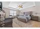 Relaxing main bedroom with tray ceiling, comfortable bed, and elegant furnishings at 6801 Louis Dr, Locust Grove, GA 30248