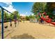 Community playground with swings, slides, and climbing structures, set against a backdrop of trees and a blue sky at 6801 Louis Dr, Locust Grove, GA 30248