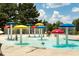 Vibrant splash pad with colorful mushroom-shaped water features for Gathering fun and recreation at 6801 Louis Dr, Locust Grove, GA 30248