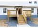 Close-up of the back deck with wooden railings and stairs leading down to a gravel-covered area at 1919 Pair Sw Rd, Marietta, GA 30008