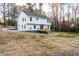 A backyard view of the home with a wooden deck and a drive way to the left at 1919 Pair Sw Rd, Marietta, GA 30008