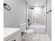 Modern bathroom features marble-tiled walls, black fixtures, and a sleek, built-in bathtub at 1919 Pair Sw Rd, Marietta, GA 30008