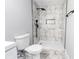 Modern bathroom featuring sleek shower with black fixtures and marble-style tile at 1919 Pair Sw Rd, Marietta, GA 30008