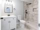 Updated bathroom featuring marble-tiled shower and floors, alongside modern white cabinets at 1919 Pair Sw Rd, Marietta, GA 30008