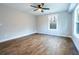 A modern bedroom with two windows, a ceiling fan and wood floors at 1919 Pair Sw Rd, Marietta, GA 30008
