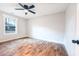 Bright bedroom with hardwood floors, a ceiling fan, and natural light from a window at 1919 Pair Sw Rd, Marietta, GA 30008