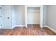 Bedroom with hardwood floors and open closet for convenient storage solutions at 1919 Pair Sw Rd, Marietta, GA 30008