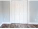 Bedroom closet features bi-fold doors, wood floor and modern paint at 1919 Pair Sw Rd, Marietta, GA 30008