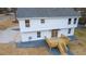 Aerial view of the rear of a white two-story home with a wooden deck at 1919 Pair Sw Rd, Marietta, GA 30008