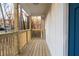 Cozy front porch with wooden railings and flooring with blue door at 1919 Pair Sw Rd, Marietta, GA 30008