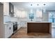 Modern kitchen with white cabinets, a wood-paneled island, stainless steel appliances, and hardwood floors at 1919 Pair Sw Rd, Marietta, GA 30008