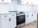 Modern kitchen with white cabinets, stainless steel oven, and hardwood floors at 1919 Pair Sw Rd, Marietta, GA 30008