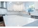 Modern kitchen with white cabinets, white countertops, stainless steel appliances, and hardwood floors at 1919 Pair Sw Rd, Marietta, GA 30008