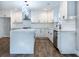 Modern kitchen with white cabinets, a large island, stainless steel appliances, and hardwood floors at 1919 Pair Sw Rd, Marietta, GA 30008