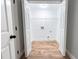 Bright laundry room features wood-look flooring, white walls, and wire shelving at 1919 Pair Sw Rd, Marietta, GA 30008