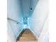 Stairway with hardwood steps and white railing leading towards a light-filled exit at 1919 Pair Sw Rd, Marietta, GA 30008