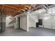 Unfinished basement with exposed ductwork, utilities, painted concrete floor, and access to garage at 441 Windsor Dr, Forest Park, GA 30297