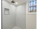 Elegant bathroom features a frameless glass shower, stylish tile, and a convenient recessed niche at 441 Windsor Dr, Forest Park, GA 30297