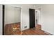 Bedroom showcasing wood flooring, white trim and a mirrored closet at 441 Windsor Dr, Forest Park, GA 30297